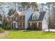 Lovely two-story brick home with attached garage and manicured lawn at 5220 Linksland Dr, Holly Springs, NC 27540