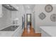 Modern kitchen showcases white cabinets, stainless appliances, and hardwood floors at 5220 Linksland Dr, Holly Springs, NC 27540
