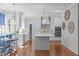 Spacious kitchen features a center island, stainless appliances, and hardwood flooring at 5220 Linksland Dr, Holly Springs, NC 27540