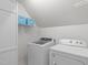 Efficient laundry area featuring washer, dryer, storage and bright white walls at 5220 Linksland Dr, Holly Springs, NC 27540