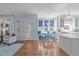 Open-concept space with hardwood floors, seamless access to seating area and an abundance of natural light at 5220 Linksland Dr, Holly Springs, NC 27540