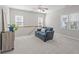 Cozy upstairs loft with a blue sofa, carpet, and windows at 5220 Linksland Dr, Holly Springs, NC 27540