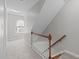 Bright staircase with wooden handrail, white spindles, and carpeted steps at 5220 Linksland Dr, Holly Springs, NC 27540
