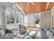 Inviting sunroom filled with natural light, featuring wicker furniture and serene views at 5220 Linksland Dr, Holly Springs, NC 27540