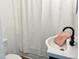 A bathroom features a white sink and shower with a black faucet and a plush peach towel at 540 S Cheatham St, Franklinton, NC 27525