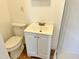 Compact bathroom features a white toilet and sink with storage underneath at 540 S Cheatham St, Franklinton, NC 27525