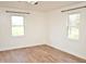 Bright bedroom features hardwood floors and two windows with views of the surrounding landscape at 540 S Cheatham St, Franklinton, NC 27525