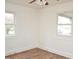 Cozy bedroom with hardwood floors, fresh paint, and natural light from dual windows at 540 S Cheatham St, Franklinton, NC 27525
