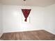 Bedroom with laminate flooring, white walls, and a red curtain framing the bright window at 540 S Cheatham St, Franklinton, NC 27525