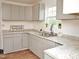 Updated kitchen with gray cabinets, granite countertops, and stainless steel sink under a window at 540 S Cheatham St, Franklinton, NC 27525