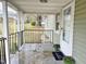 Covered porch area with a black metal railing and a welcome mat, creating a warm entry at 540 S Cheatham St, Franklinton, NC 27525