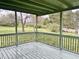 Enclosed porch showcases green wood, providing an idyllic setting for outdoor enjoyment at 540 S Cheatham St, Franklinton, NC 27525