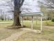 Open yard with a brick-lined pathway and a pergola feature, enhancing the curb appeal at 540 S Cheatham St, Franklinton, NC 27525