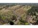 Aerial view of a home nestled among trees and fields, showcasing the vast natural surroundings at 55 J B Rd, Louisburg, NC 27549