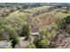 Aerial view of a house surrounded by lush, green trees and a grassy field, showing the landscape at 55 J B Rd, Louisburg, NC 27549