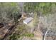 Aerial view of a secluded single-story home surrounded by lush greenery and mature trees, offering privacy at 55 J B Rd, Louisburg, NC 27549