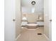En-suite bathroom featuring double vanities, a large bathtub, tile floors, and a skylight at 55 J B Rd, Louisburg, NC 27549