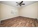 Bedroom with wood-look floors, neutral paint, and large windows for natural light at 55 J B Rd, Louisburg, NC 27549