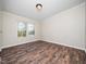 A bedroom space bathed in natural light, complemented by wood flooring, and bright white walls at 55 J B Rd, Louisburg, NC 27549