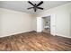 Bedroom with wood-look floors and a ceiling fan, connecting to an en-suite bathroom at 55 J B Rd, Louisburg, NC 27549