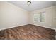 Cozy bedroom featuring wood floors and double windows offering backyard view and natural light at 55 J B Rd, Louisburg, NC 27549