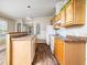 Bright kitchen featuring wooden cabinets, white appliances, an island, and wood-style flooring at 55 J B Rd, Louisburg, NC 27549