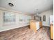 Well-lit kitchen with ample countertop space, wooden cabinetry, and an adjacent dining area at 55 J B Rd, Louisburg, NC 27549