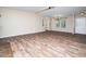 Open-concept living room featuring wood-look floors, neutral walls, and a view into dining at 55 J B Rd, Louisburg, NC 27549