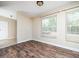 Living room boasting wood-look floors, a large window for natural light, and neutral colored walls at 55 J B Rd, Louisburg, NC 27549