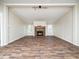 Bright living room featuring a stone fireplace, wood-look floors, and neutral paint at 55 J B Rd, Louisburg, NC 27549