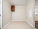 An empty utility room with tile flooring, white walls, and minimalist design elements at 55 J B Rd, Louisburg, NC 27549