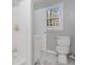 Bathroom with white shower and cabinets, featuring a toilet and a window to the outside at 5917 Meadowlark Ln, Raleigh, NC 27610