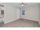 A well-lit bedroom with light grey laminate flooring, a ceiling fan, and bright natural light at 5917 Meadowlark Ln, Raleigh, NC 27610