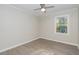 A spacious bedroom with wood-look flooring, neutral walls, bright windows, and a modern ceiling fan at 5917 Meadowlark Ln, Raleigh, NC 27610