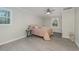 Bedroom with hardwood flooring, light walls, and a ceiling fan for a bright and airy feel at 5917 Meadowlark Ln, Raleigh, NC 27610