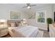 Bedroom featuring a bed with throw pillows, rug, 2 side tables, and windows for ample natural light at 5917 Meadowlark Ln, Raleigh, NC 27610
