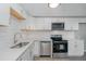 Stylish kitchen with stainless steel appliances, white cabinetry, and granite countertops at 5917 Meadowlark Ln, Raleigh, NC 27610