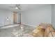 View of the living room with a comfortable couch, large glass window, and gray walls at 5917 Meadowlark Ln, Raleigh, NC 27610