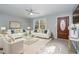 Bright living room featuring modern furniture, fresh paint and a beautiful front door at 5917 Meadowlark Ln, Raleigh, NC 27610