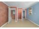 A room with a brick wall, featuring multiple doorways to other areas of the home at 5917 Meadowlark Ln, Raleigh, NC 27610
