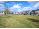 Exterior view of townhomes in a community lawn and green space at 5918 Giddings St, Raleigh, NC 27616