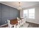 Dining room with modern chandelier, dark accent wall, and a wooden dining table at 5918 Giddings St, Raleigh, NC 27616