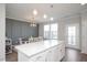Large kitchen island with white cabinetry and stainless steel appliances at 5918 Giddings St, Raleigh, NC 27616