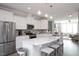 Modern kitchen with stainless steel appliances, white cabinets, and a large center island at 5918 Giddings St, Raleigh, NC 27616