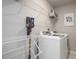 Functional laundry room with white appliances, shelving, and a drying rack for convenience at 5918 Giddings St, Raleigh, NC 27616