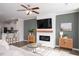 Cozy living room with modern fireplace, mounted TV, ceiling fan, and stylish decor at 5918 Giddings St, Raleigh, NC 27616
