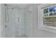 Modern bathroom with tile shower, built-in niche, and natural light from the window at 602 Dunbar St, Durham, NC 27701