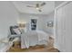 Cozy bedroom with a ceiling fan, closet, a window with natural light and a wall-mounted television at 602 Dunbar St, Durham, NC 27701