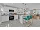 Well-lit kitchen with stainless appliances, island seating, and open view into the dining room at 602 Dunbar St, Durham, NC 27701