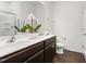 Well-lit bathroom featuring a double sink vanity, a large mirror, and a walk-in shower at 6021 Watsonia Dr, Zebulon, NC 27597